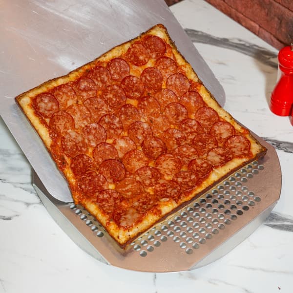 A metal pizza peel - a stand-in for the Ooni 14-Inch Perforated Pizza Peel, not a photograph of this model