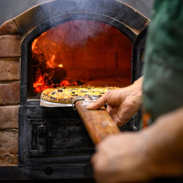 A small round turning peel - a stand-in for the Ooni 7-Inch Pizza Turning Peel, not a photograph of this model
