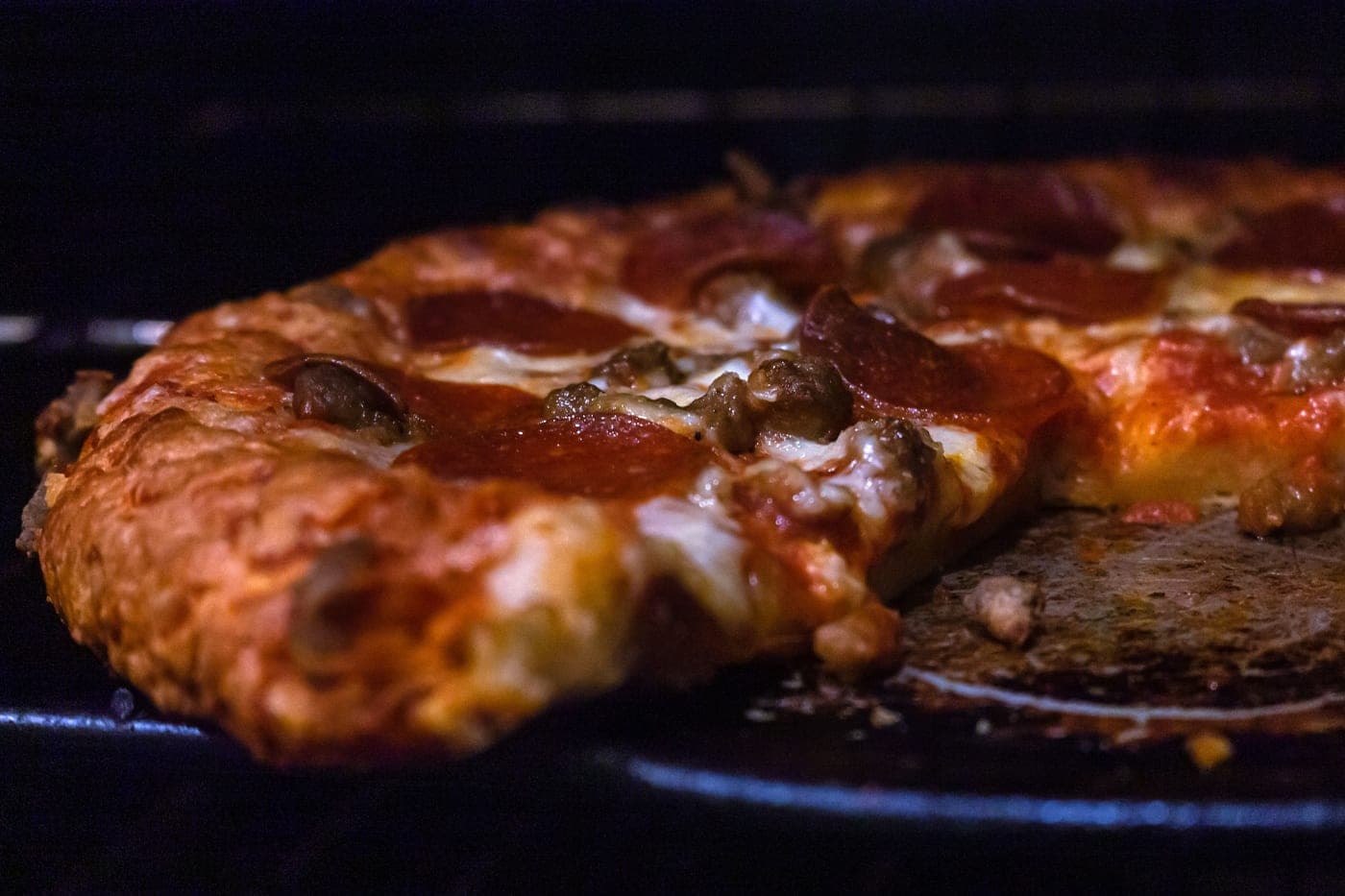The browned, blistered edge of a home-baked pizza crust